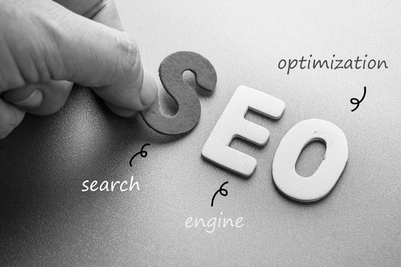 person placing letters for SEO search engine optimization on a table