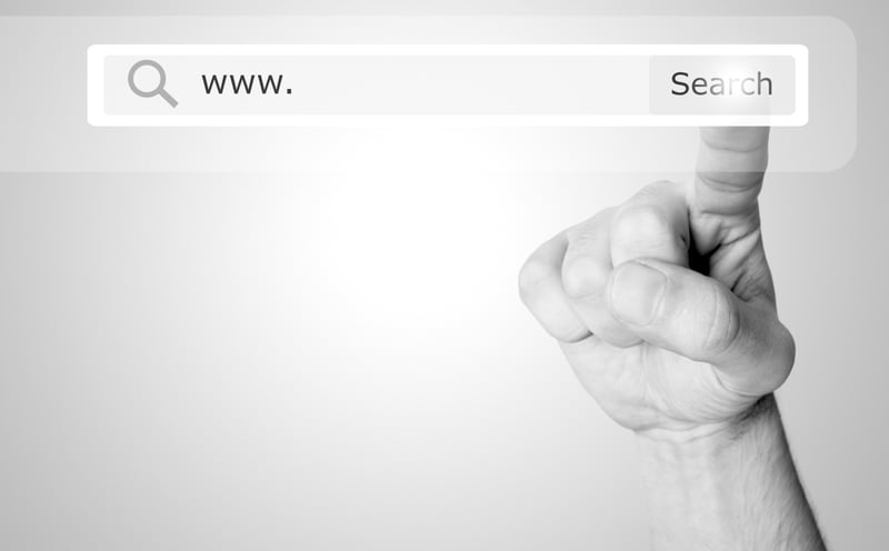 hand tapping search bar on a website