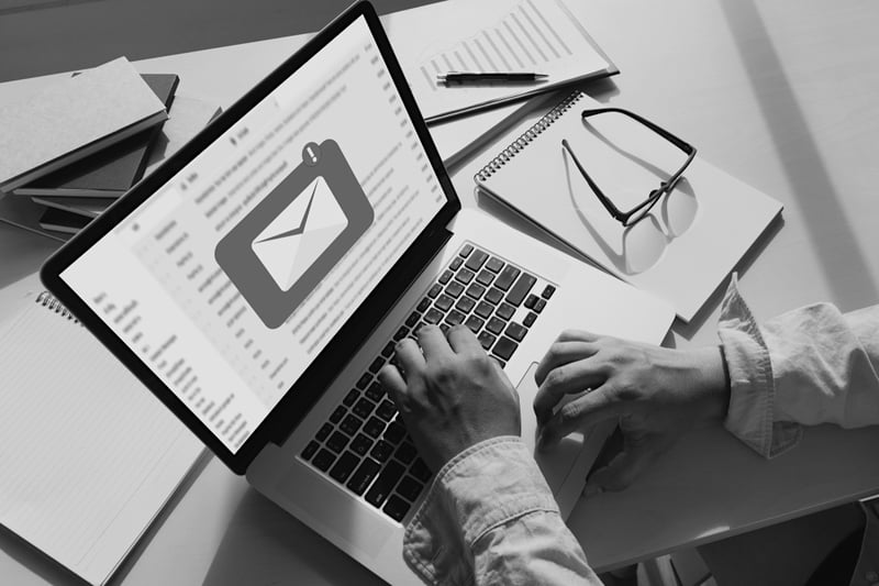 marketer sitting at desk and checking email notification