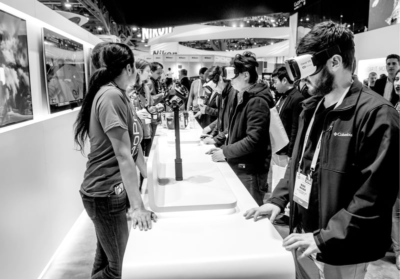 group of people testing virtual reality headgear at electronics conference