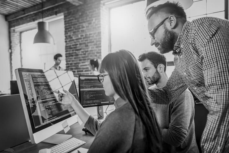 marketing team analyzing website design mistakes on computer